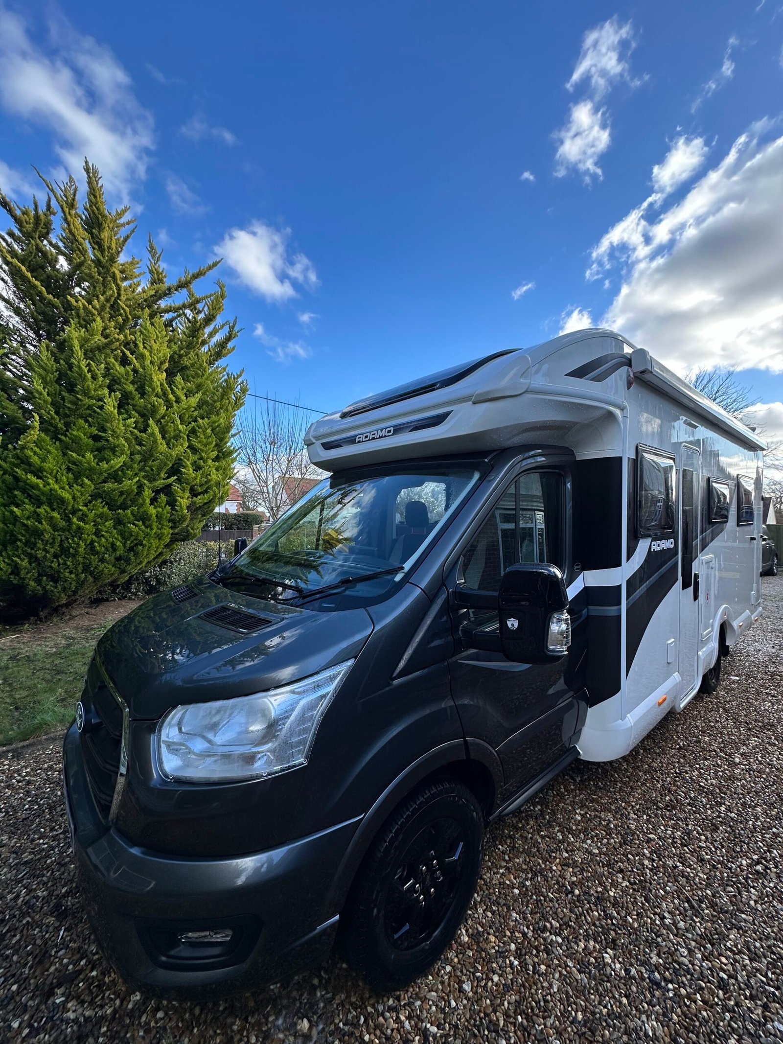 Daisy, the Bailey Adamo 75-4DL motorhome, on the drive under a blue sky