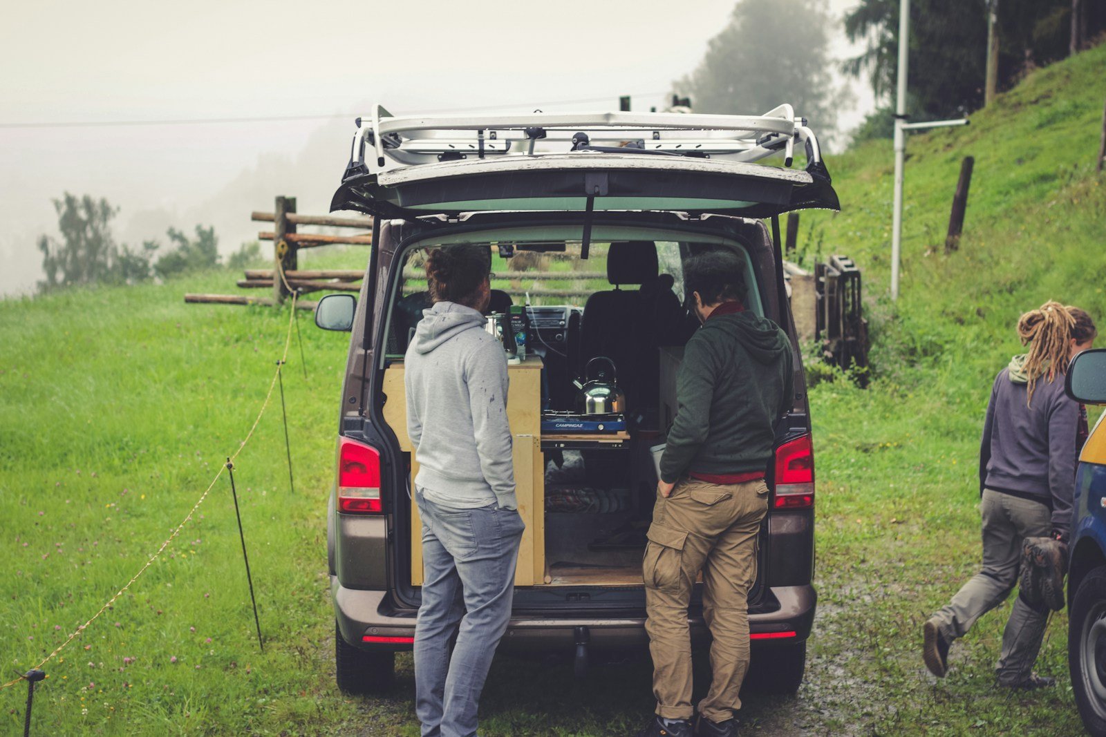 Getting ready at the open back of a campervan