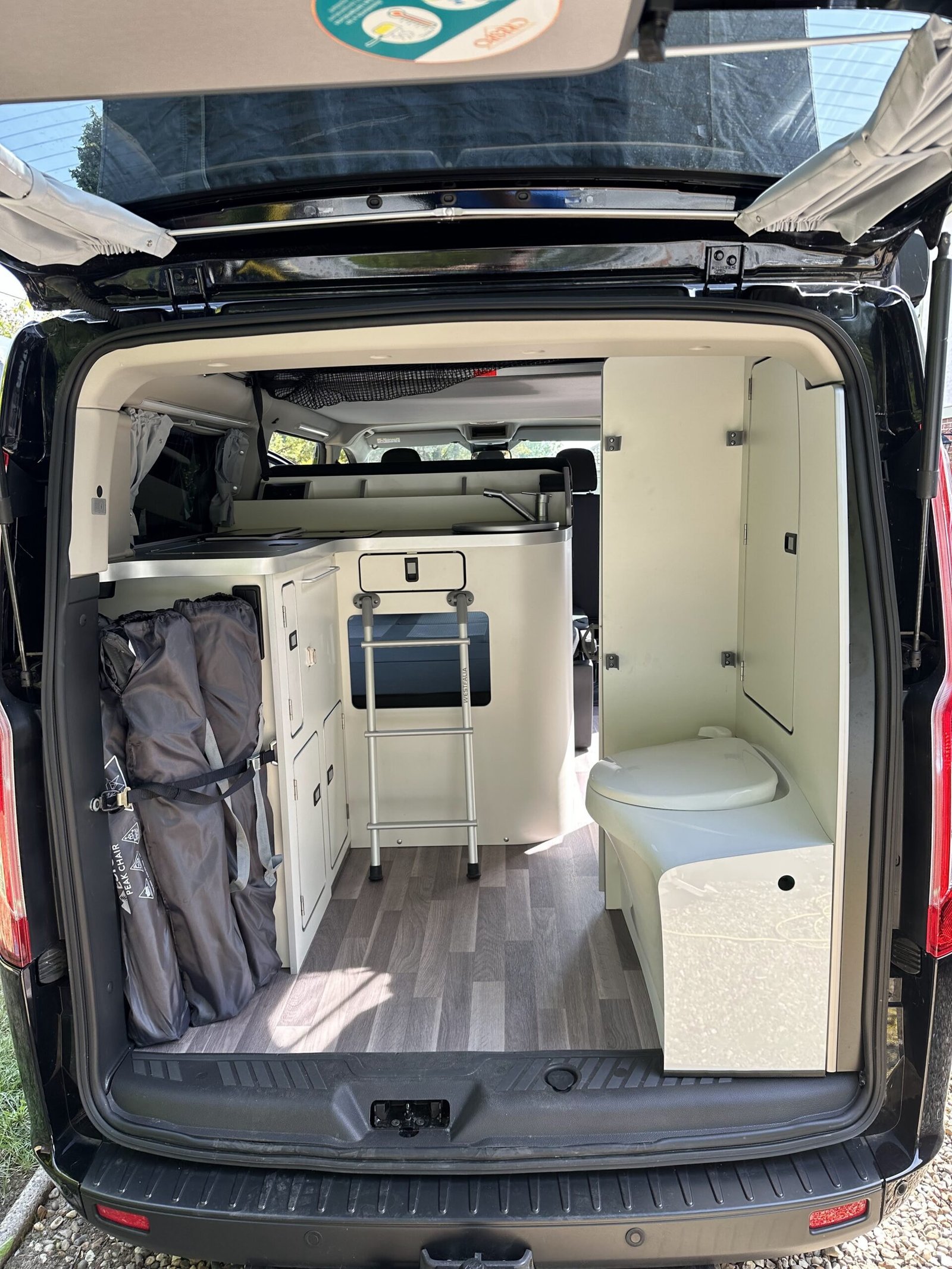 The L-shaped kitchen with the toilet compartment beyond