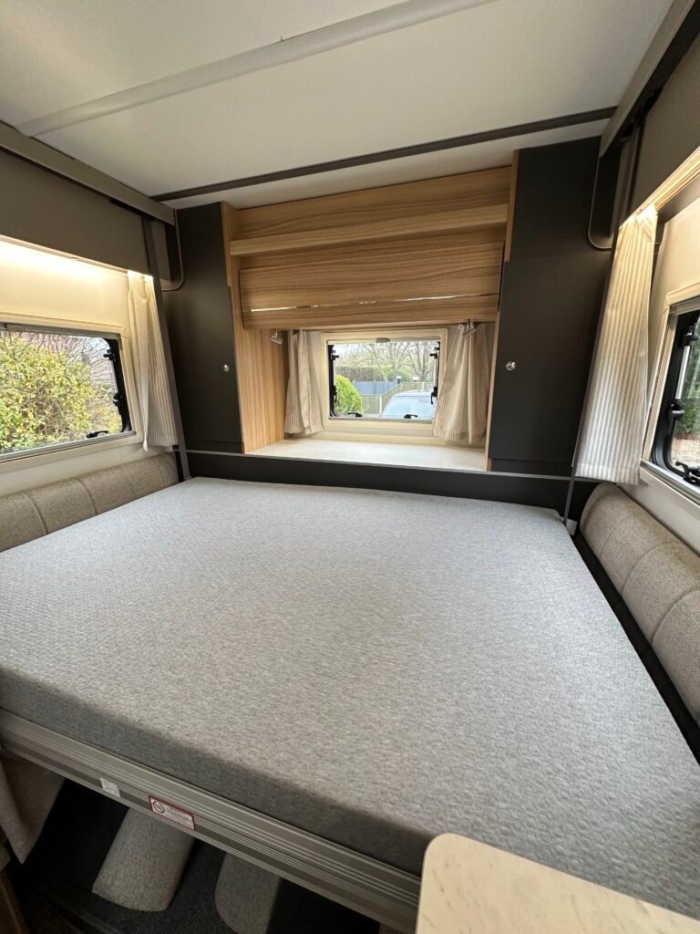 The rear bed, running the width of the van